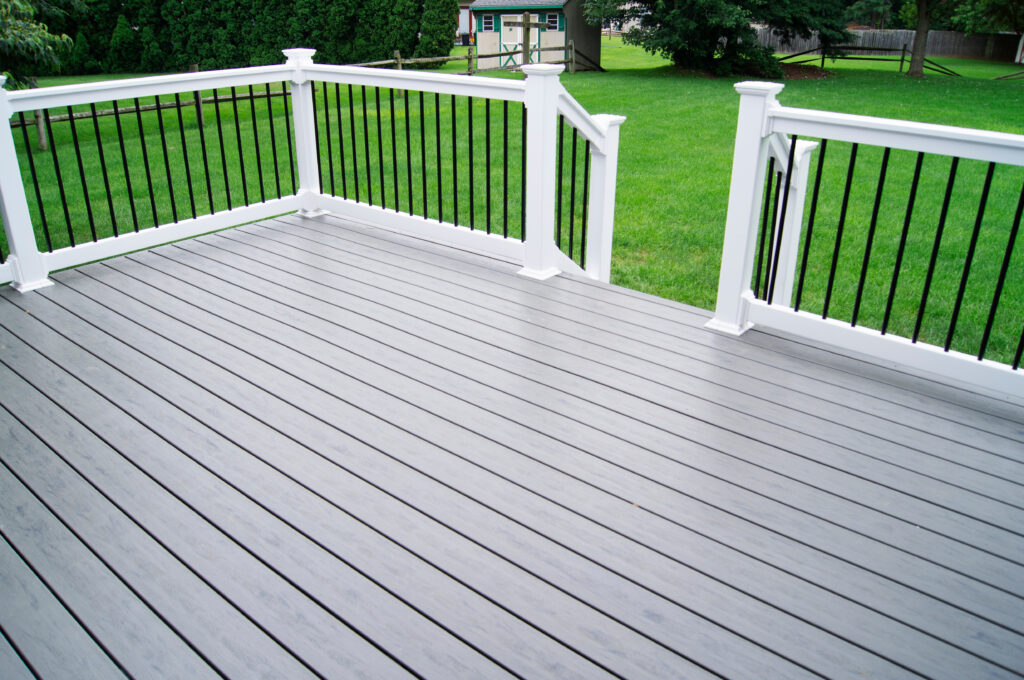 Composite gray deck with white composite handrail and black pickets